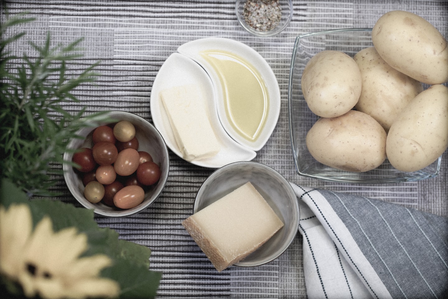 Raw food ingredients arranged on a striped tablecloth.