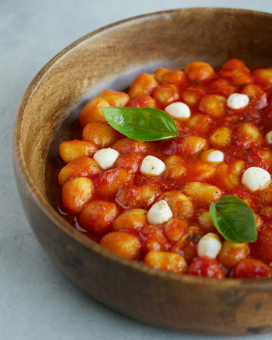 Potato gnocchi with tomato sauce and mozzarella in a bowl.